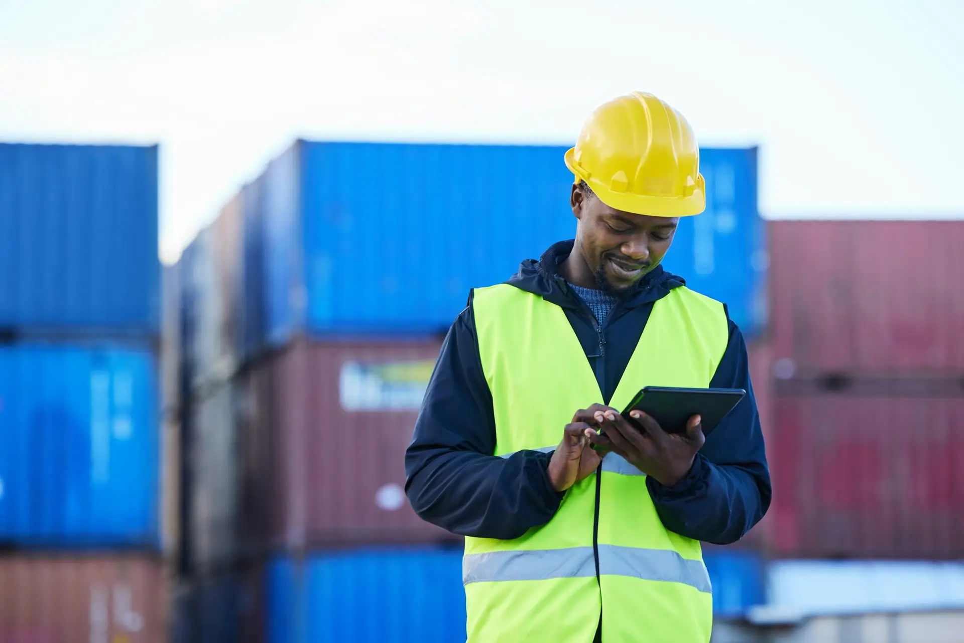 Logistics, digital tablet and black man in supply chain management at shipping, cargo or freight wa